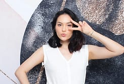 Guest flashing a peace sign in front of a glitter backdrop